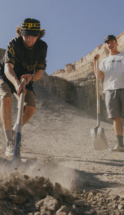 A looping collection of images featuring models out in the desert wearing 686 Unwork shorts and pants on a mountain bike track.